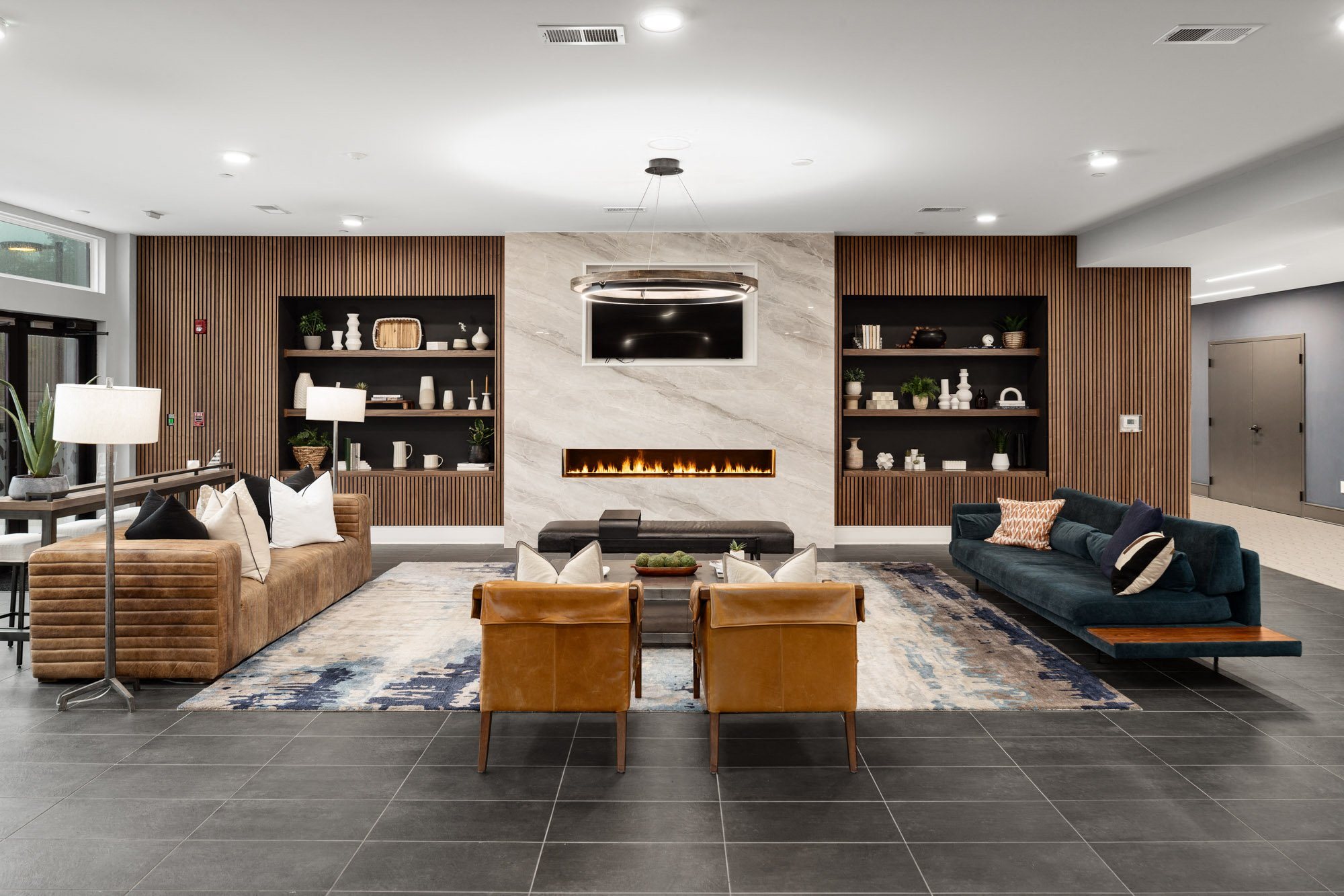 a living room with a fireplace and a couch and chairs